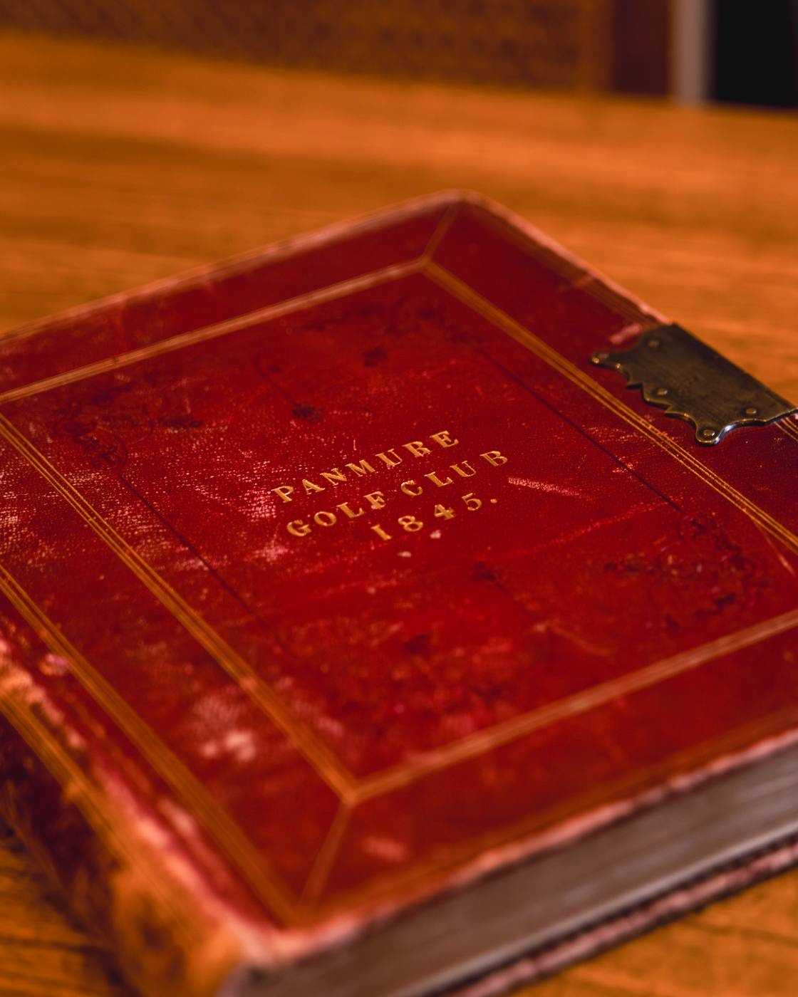 The 1845 minute book open on a table, the founding constitution in ink