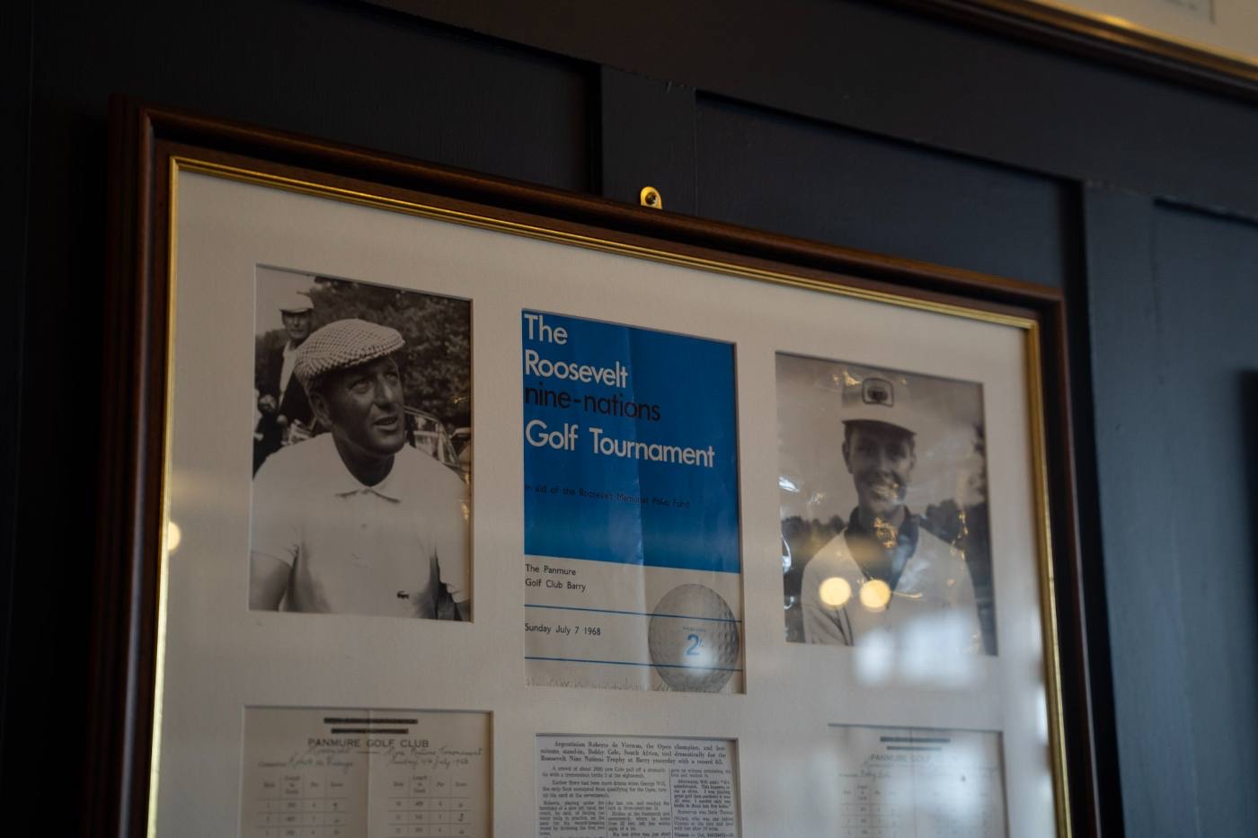 Framed memorabilia: Hogan photographs either side of a Roosevelt nine-nations tournament poster, with a scorecard mounted beneath